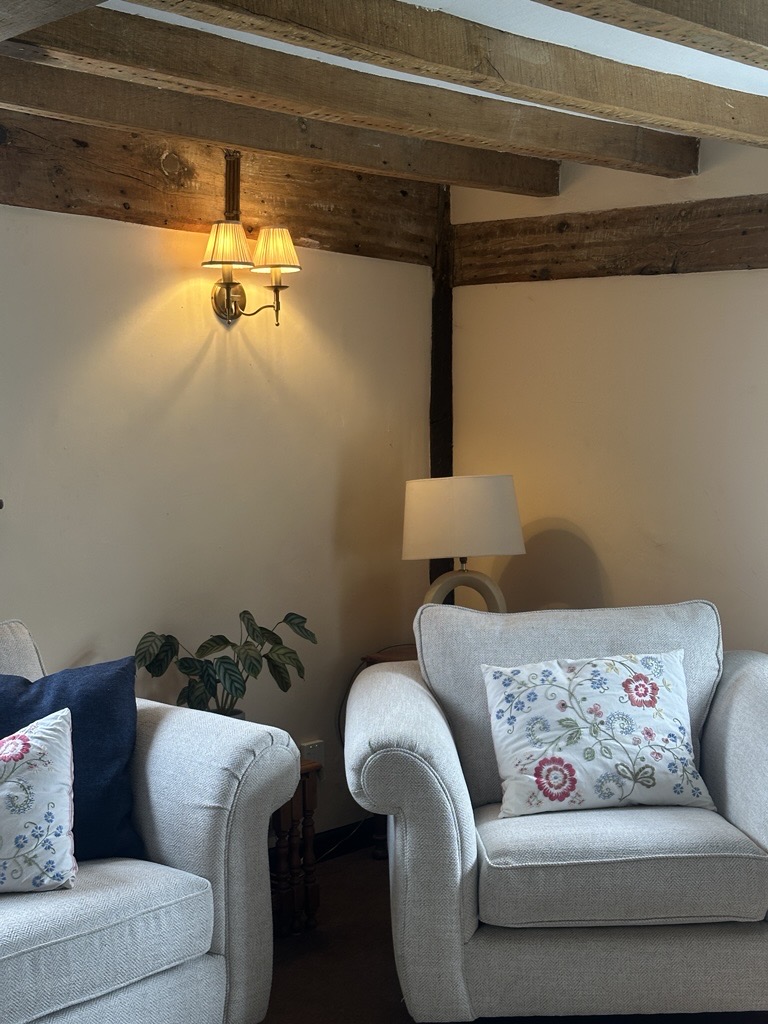 Cottage snug with armchairs and warm lamp light